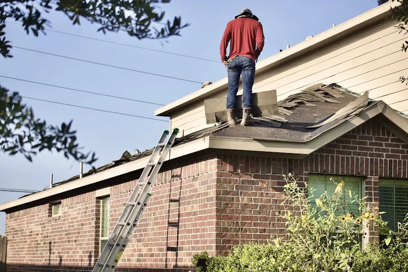 Professional roofer working on a residential roof in Bammel